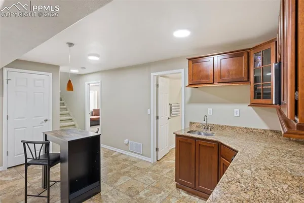a kitchen with stainless steel appliances granite countertop a sink counter space and cabinets