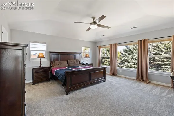 a spacious bedroom with a bed and a large window