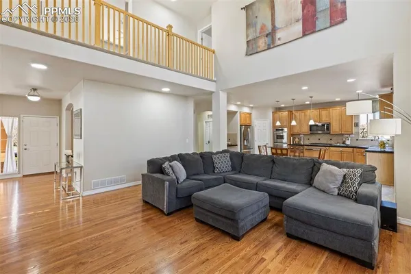 a living room with furniture and kitchen view