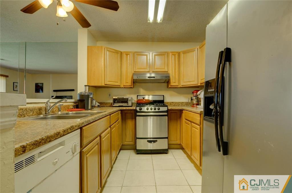 512 Edpas Road, Unit 512 New Brunswick, NJ 08901 - Photo 2 of 19 a kitchen with stainless steel appliances granite countertop a stove a sink and a refrigerator