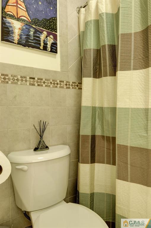 512 Edpas Road, Unit 512 New Brunswick, NJ 08901 - Photo 13 of 19 a white toilet sitting next to a bathroom sink