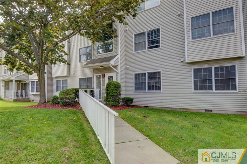 512 Edpas Road, Unit 512 New Brunswick, NJ 08901 - Photo 17 of 19 a front view of a house with a yard and garage