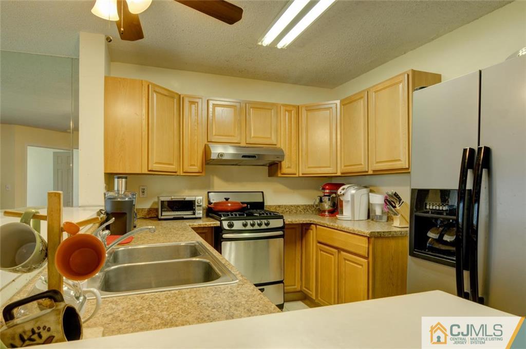 512 Edpas Road, Unit 512 New Brunswick, NJ 08901 - Photo 3 of 19 a kitchen with a sink a stove and a refrigerator
