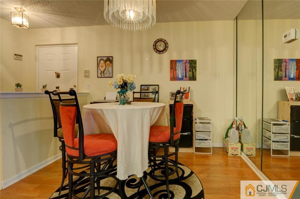 512 Edpas Road, Unit 512 New Brunswick, NJ 08901 - Photo 4 of 19 a dining room with furniture and wooden floor