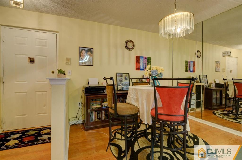 512 Edpas Road, Unit 512 New Brunswick, NJ 08901 - Photo 5 of 19 a dining room with furniture and wooden floor
