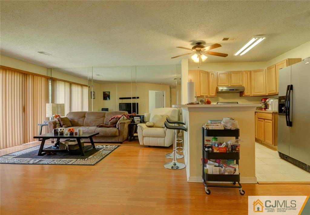 512 Edpas Road, Unit 512 New Brunswick, NJ 08901 - Photo 6 of 19 a living room with furniture and a flat screen tv