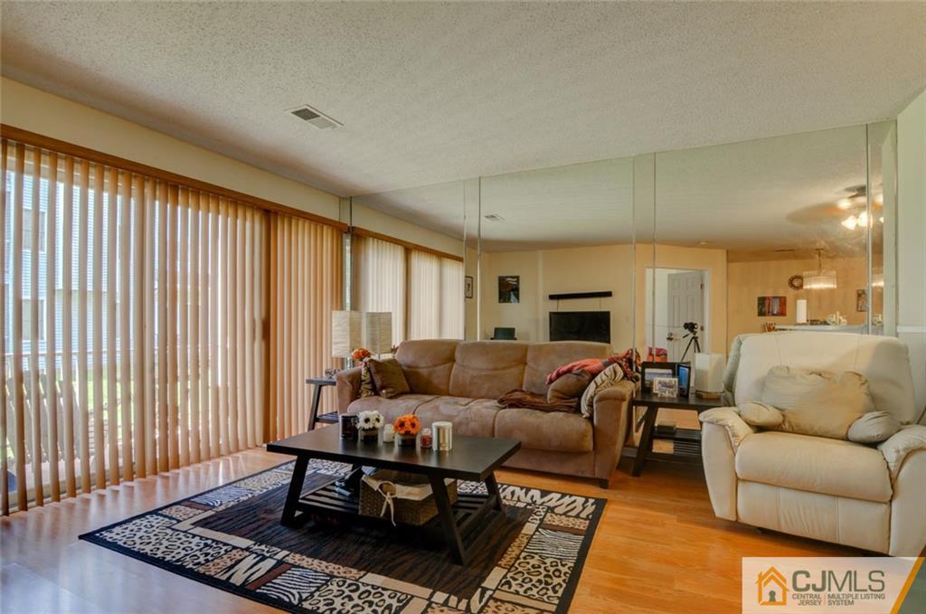 512 Edpas Road, Unit 512 New Brunswick, NJ 08901 - Photo 7 of 19 a living room with furniture and a window