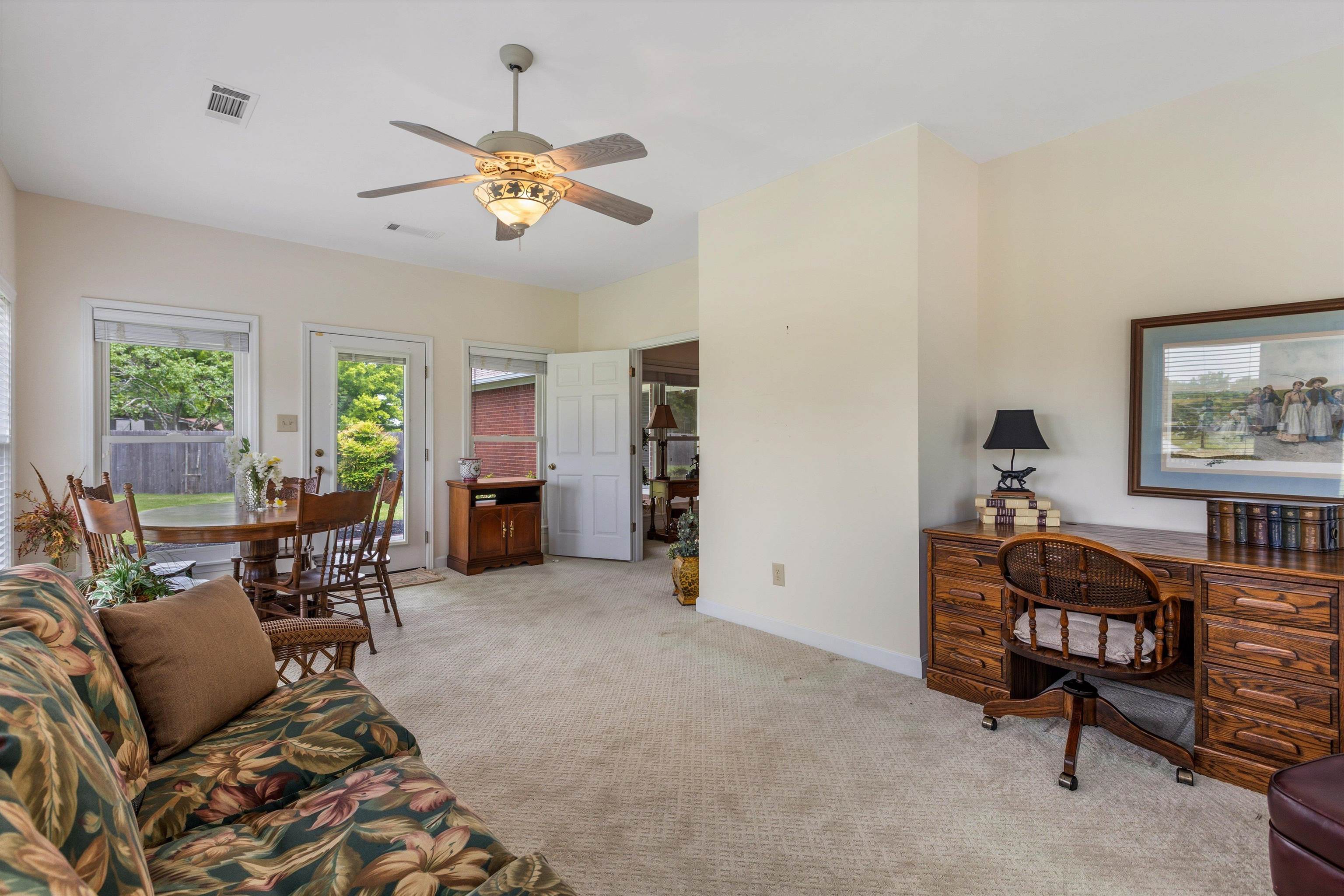 2225 Candy Lane Burlison, TN 38015 - Photo 11 of 27 Carpeted interior space featuring a ceiling fan with light, multiple windows, and a glass-paneled door