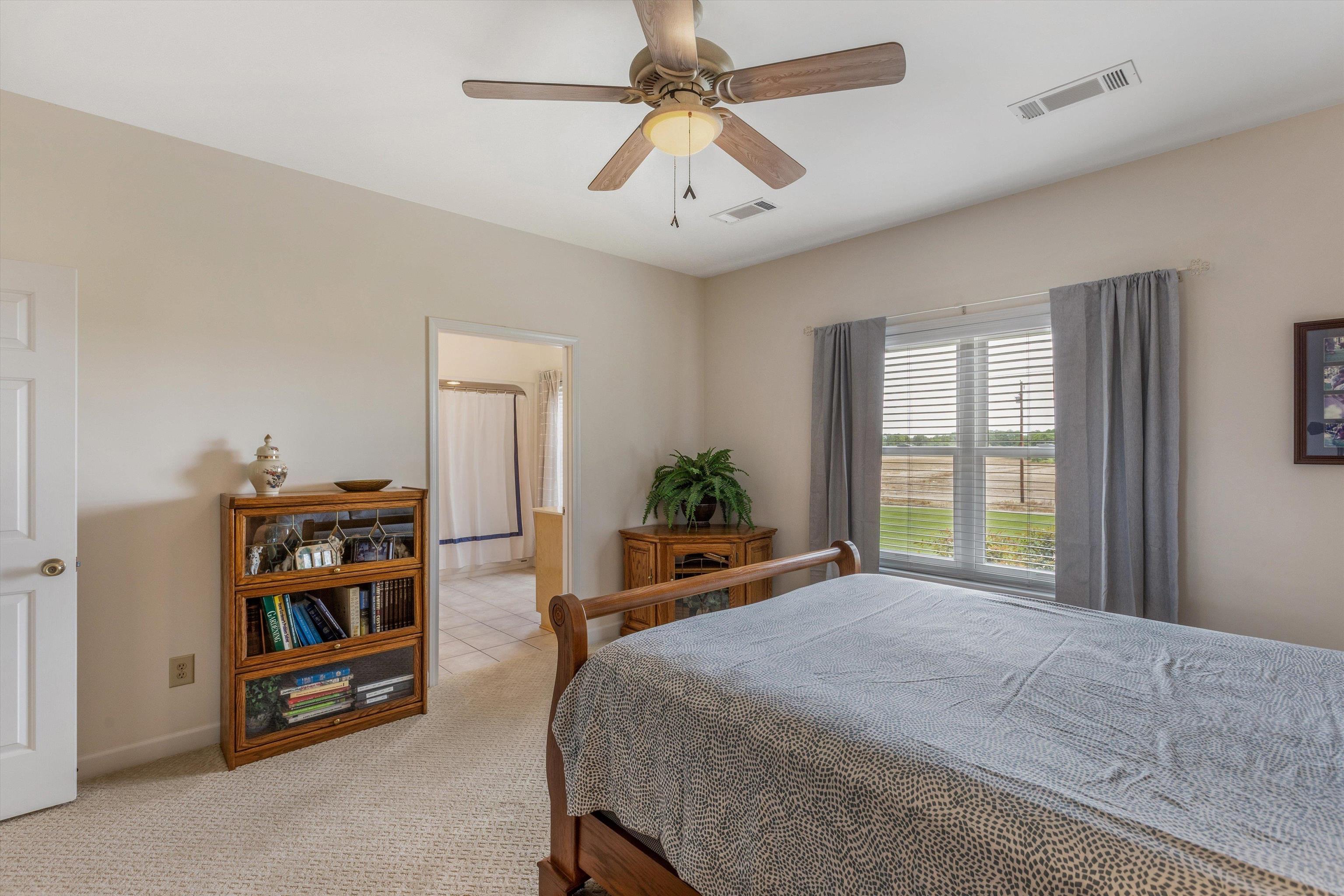 2225 Candy Lane Burlison, TN 38015 - Photo 14 of 27 Bedroom featuring light neutral wall paint, a ceiling fan with light fixture, carpeted flooring, and a window with blinds and drapery