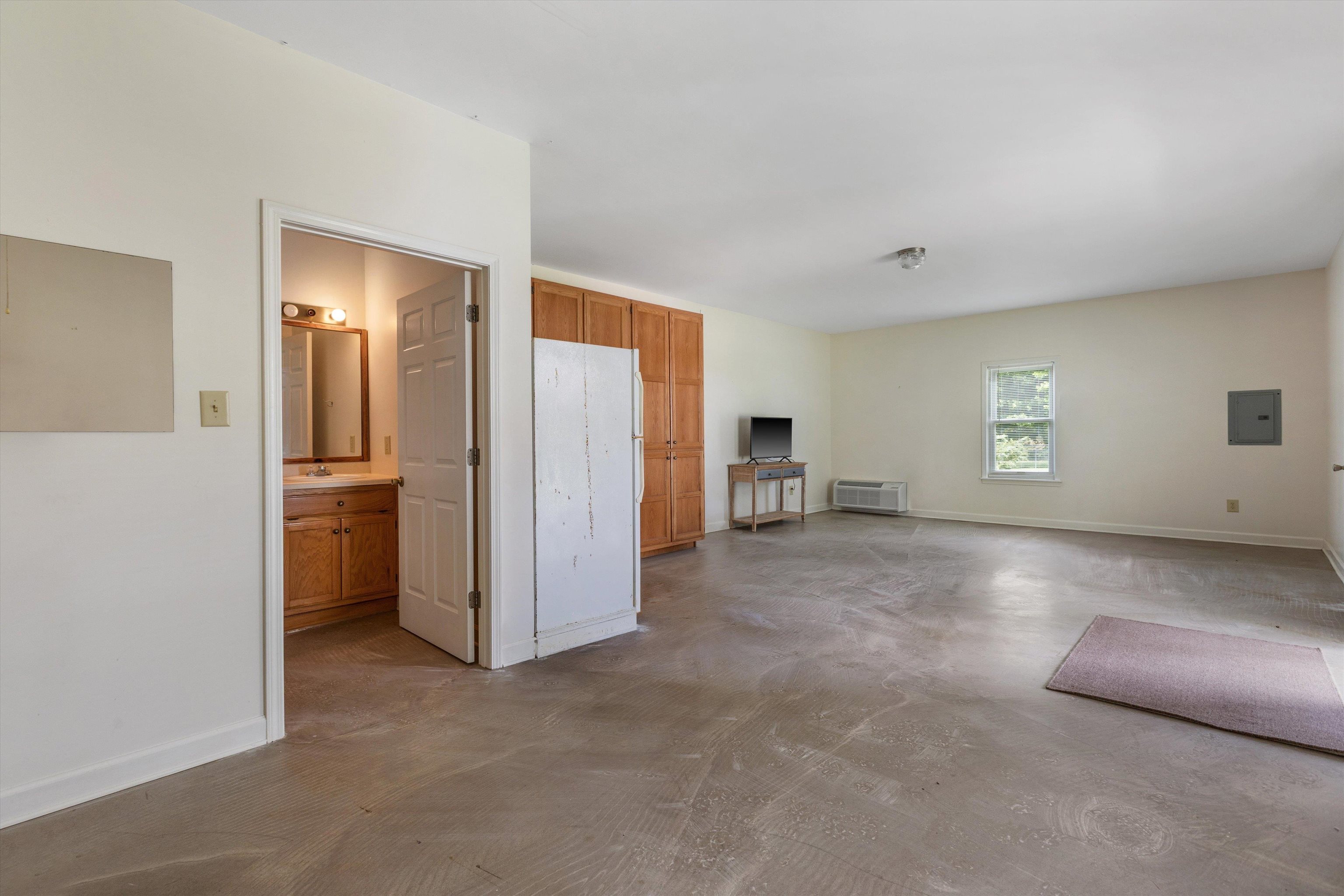 2225 Candy Lane Burlison, TN 38015 - Photo 21 of 27 Spacious open area featuring concrete flooring, a single window, and painted walls
