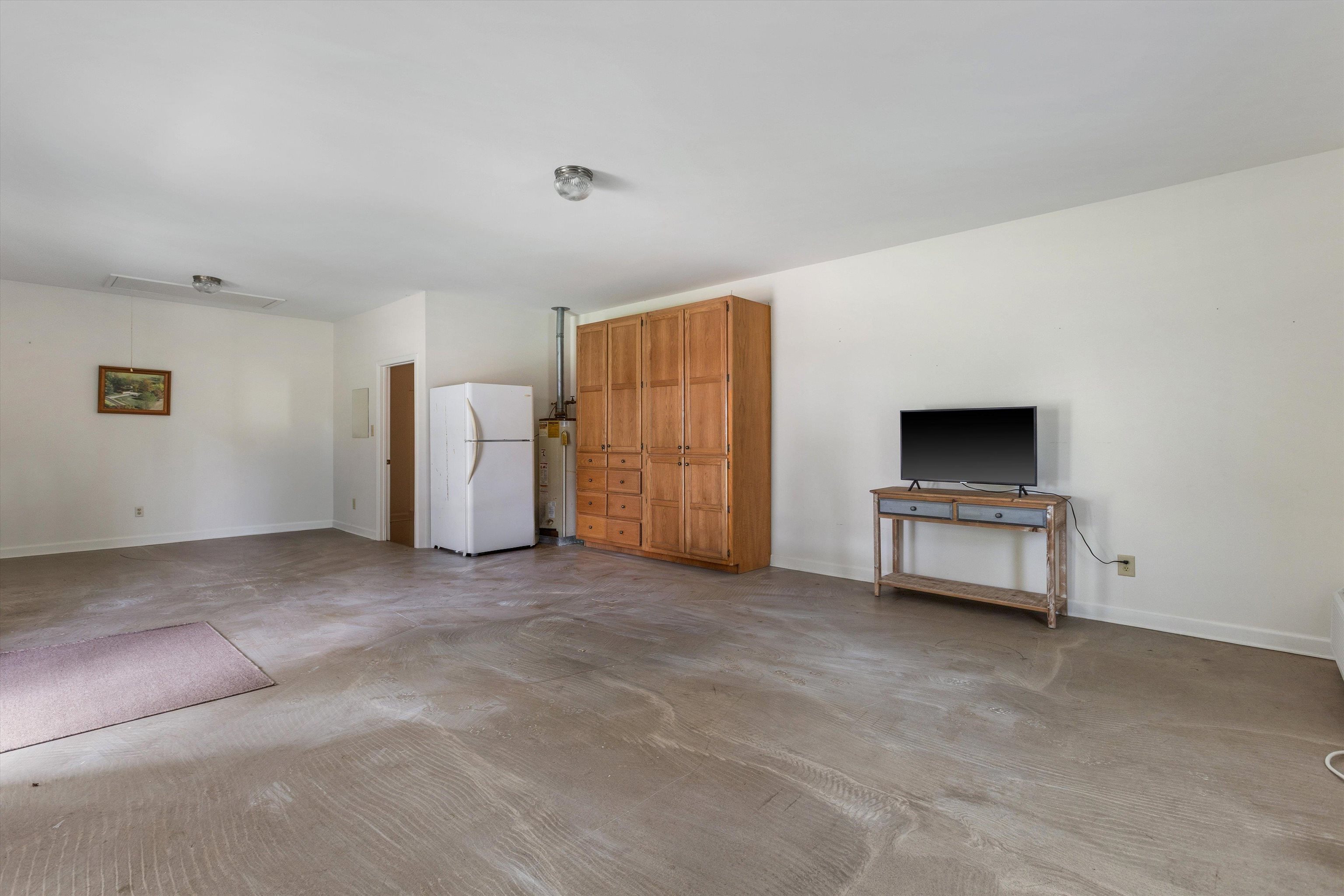 2225 Candy Lane Burlison, TN 38015 - Photo 22 of 27 Expansive multi-purpose room featuring a neutral color palette, built-in wood cabinetry, and a solid door leading to another area