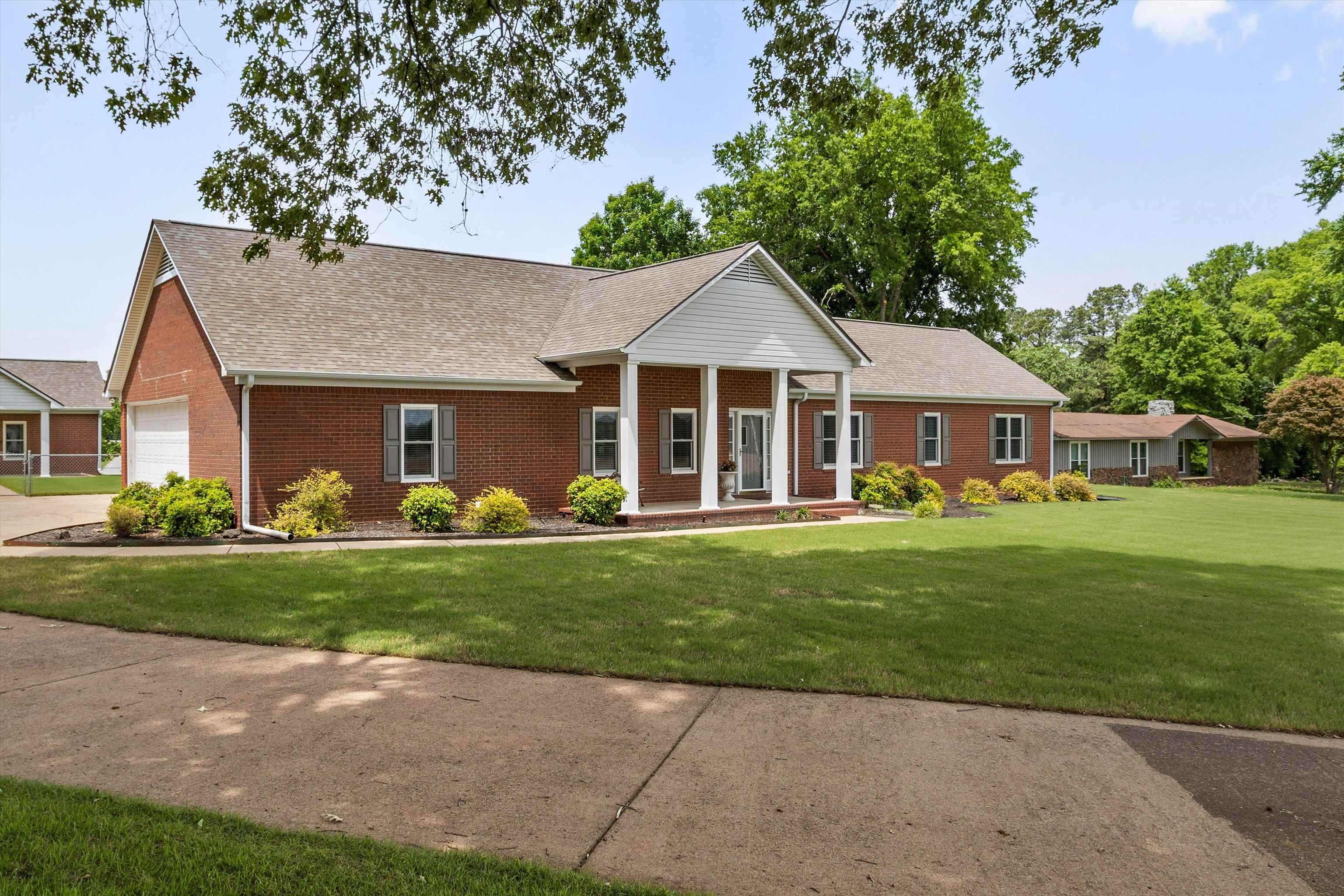2225 Candy Lane Burlison, TN 38015 - Photo 3 of 27 Traditional brick exterior with an inviting covered porch featuring white columns