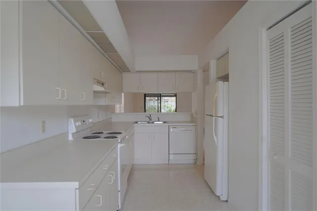 a kitchen with cabinets and window