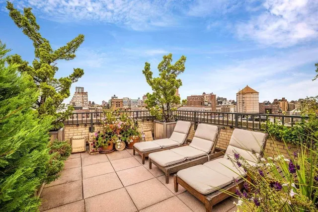 a terrace with outdoor seating city view and barbeque oven