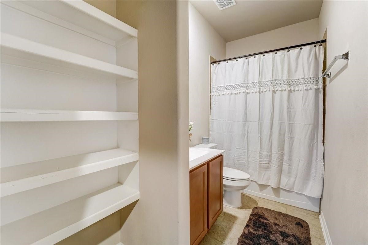 8827 Willet Street Baytown, TX 77521 - Photo 11 of 18 a bathroom with a sink toilet and shower