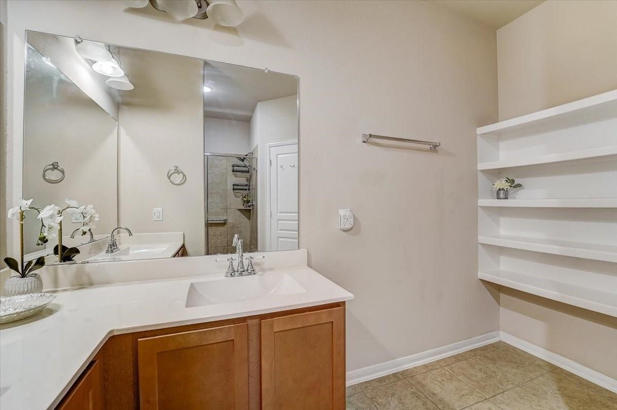 8827 Willet Street Baytown, TX 77521 - Photo 13 of 18 a bathroom with a sink and a mirror