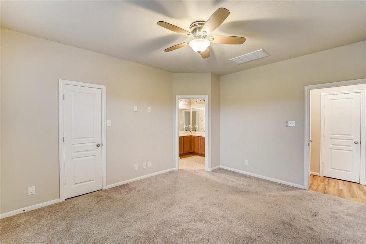 8827 Willet Street Baytown, TX 77521 - Photo 17 of 18 an empty room with fan and a ceiling fan
