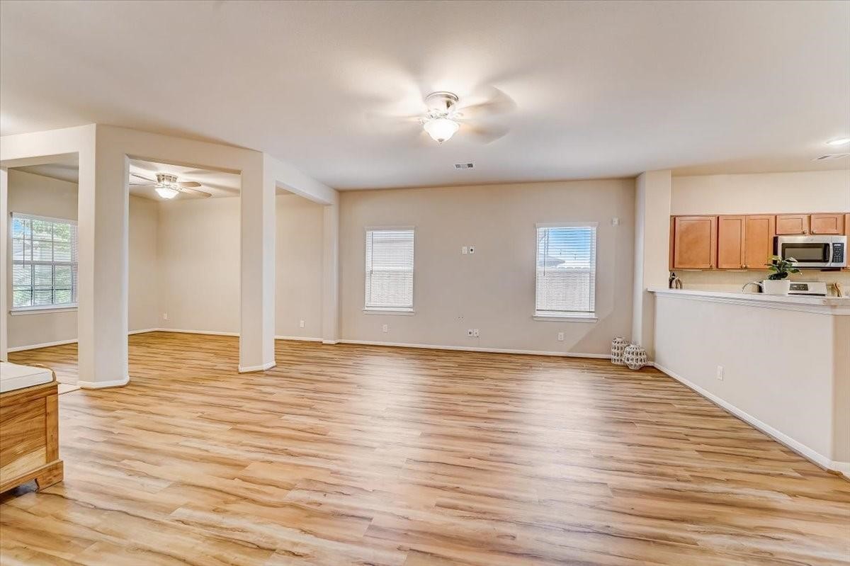8827 Willet Street Baytown, TX 77521 - Photo 3 of 18 a view of a kitchen with wooden floor and a kitchen