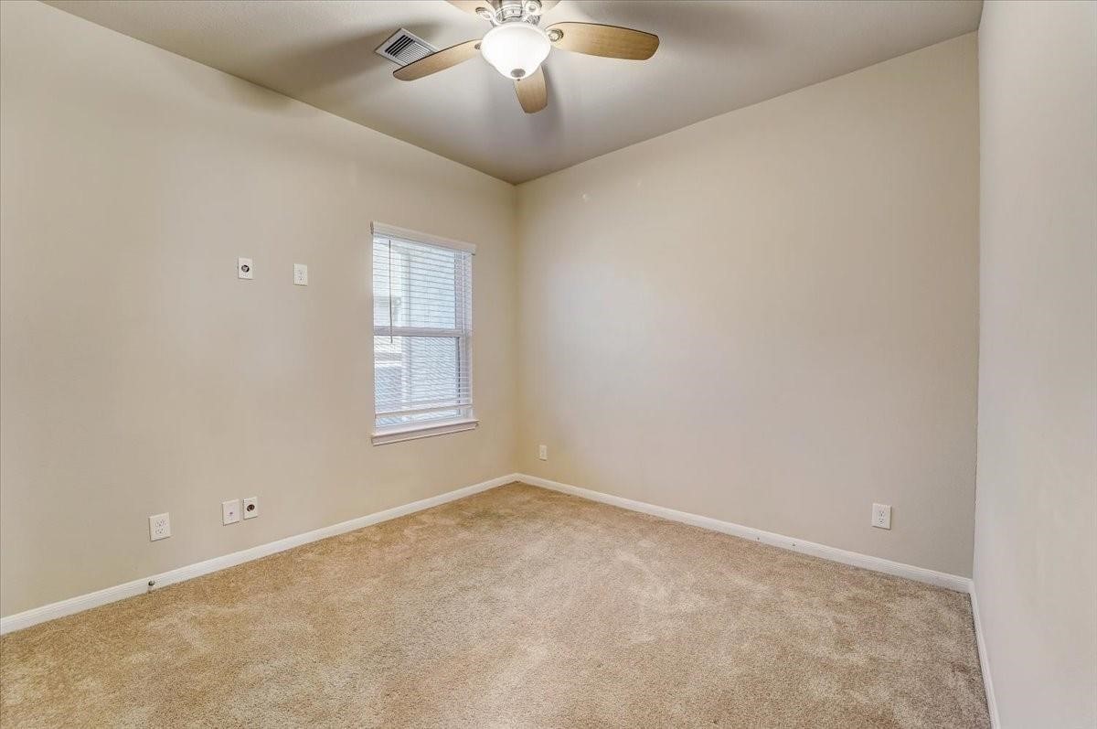 8827 Willet Street Baytown, TX 77521 - Photo 8 of 18 wooden floor in an empty room with a window