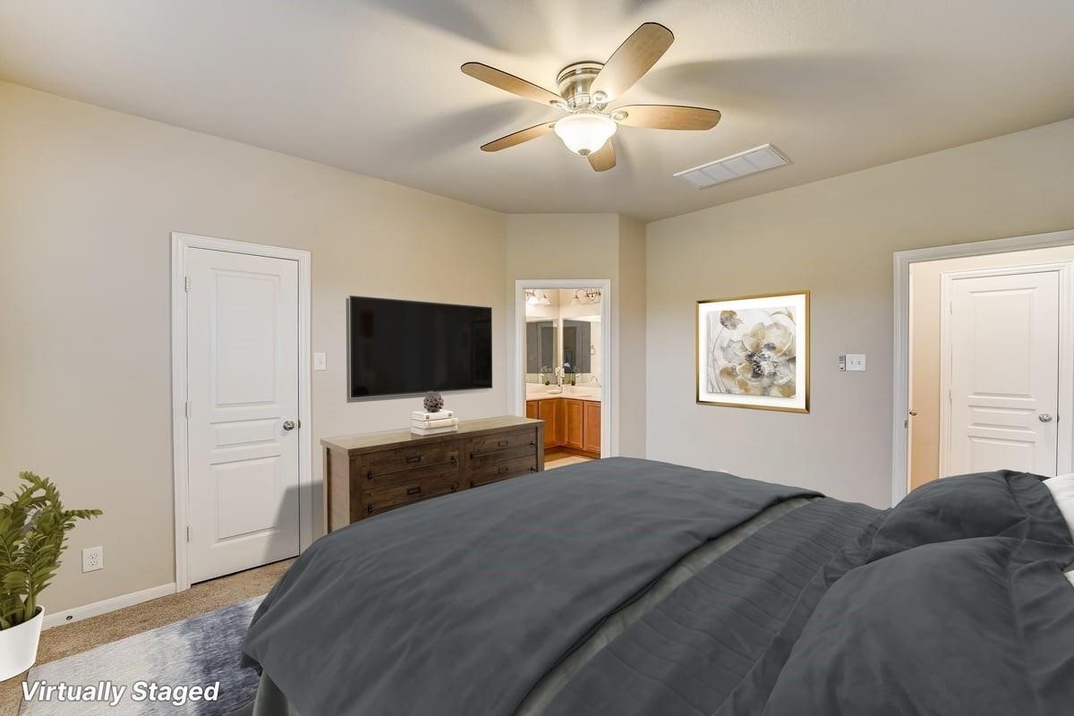 8827 Willet Street Baytown, TX 77521 - Photo 9 of 18 a bedroom with a bed and a flat screen tv