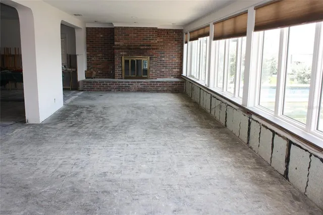 wooden floor in an empty room with a fireplace