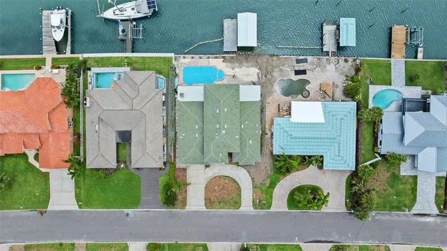 an aerial view of a house with swimming pool and garden