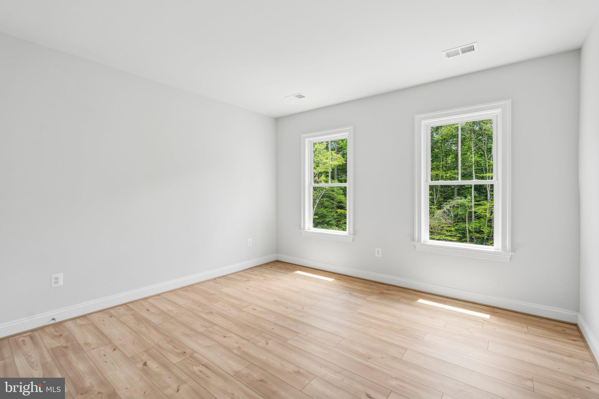 13749 Orlando Road Nokesville, VA 20181 - Photo 11 of 42 an empty room with wooden floor and windows
