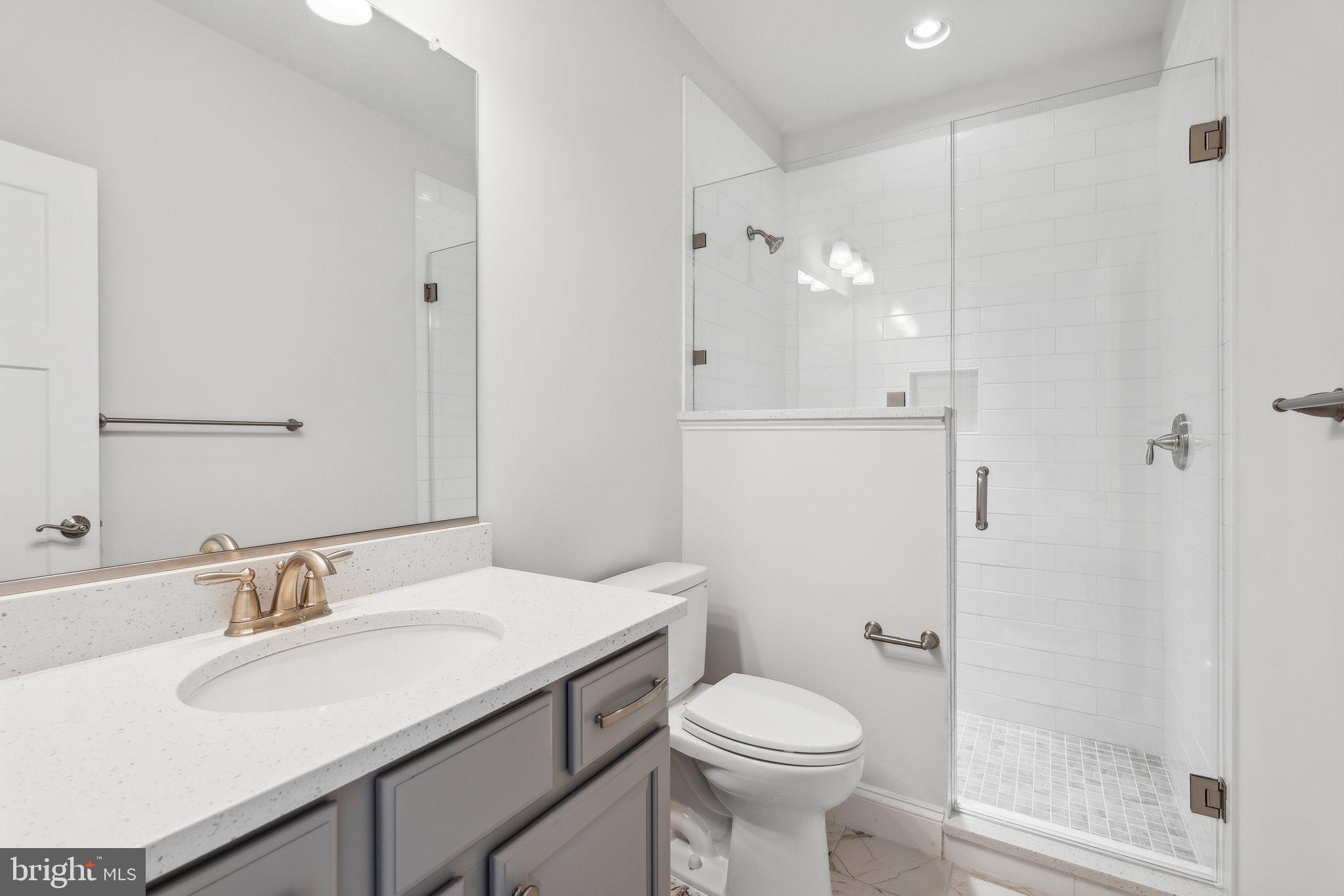 13749 Orlando Road Nokesville, VA 20181 - Photo 12 of 42 a bathroom with a sink toilet and shower