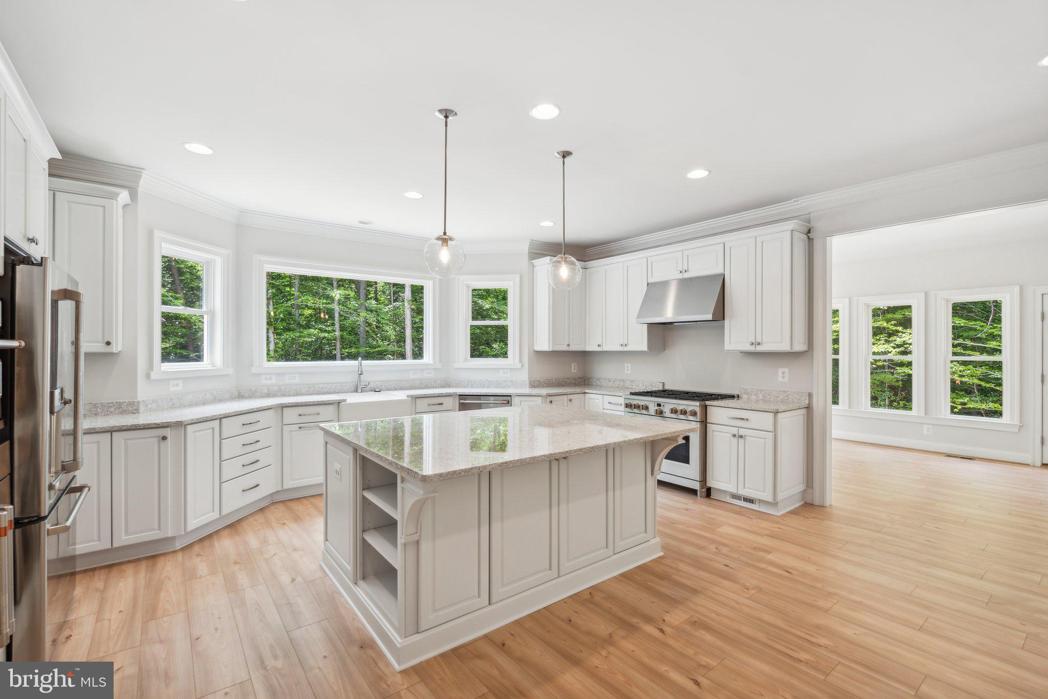 13749 Orlando Road Nokesville, VA 20181 - Photo 40 of 42 a large kitchen with stainless steel appliances granite countertop a sink a stove a refrigerator a center island and wooden floor