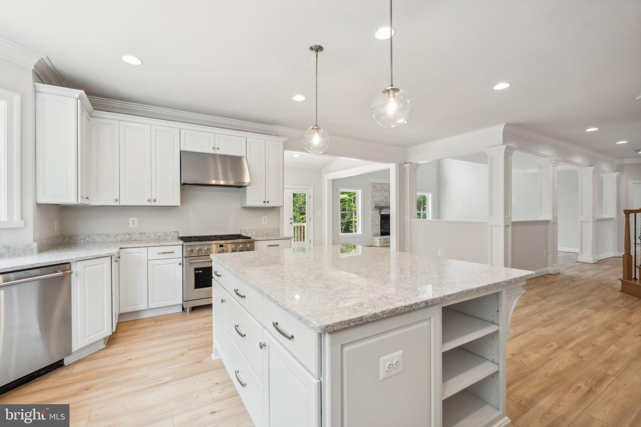 13749 Orlando Road Nokesville, VA 20181 - Photo 42 of 42 a kitchen with kitchen island granite countertop a stove a sink a center island and cabinets