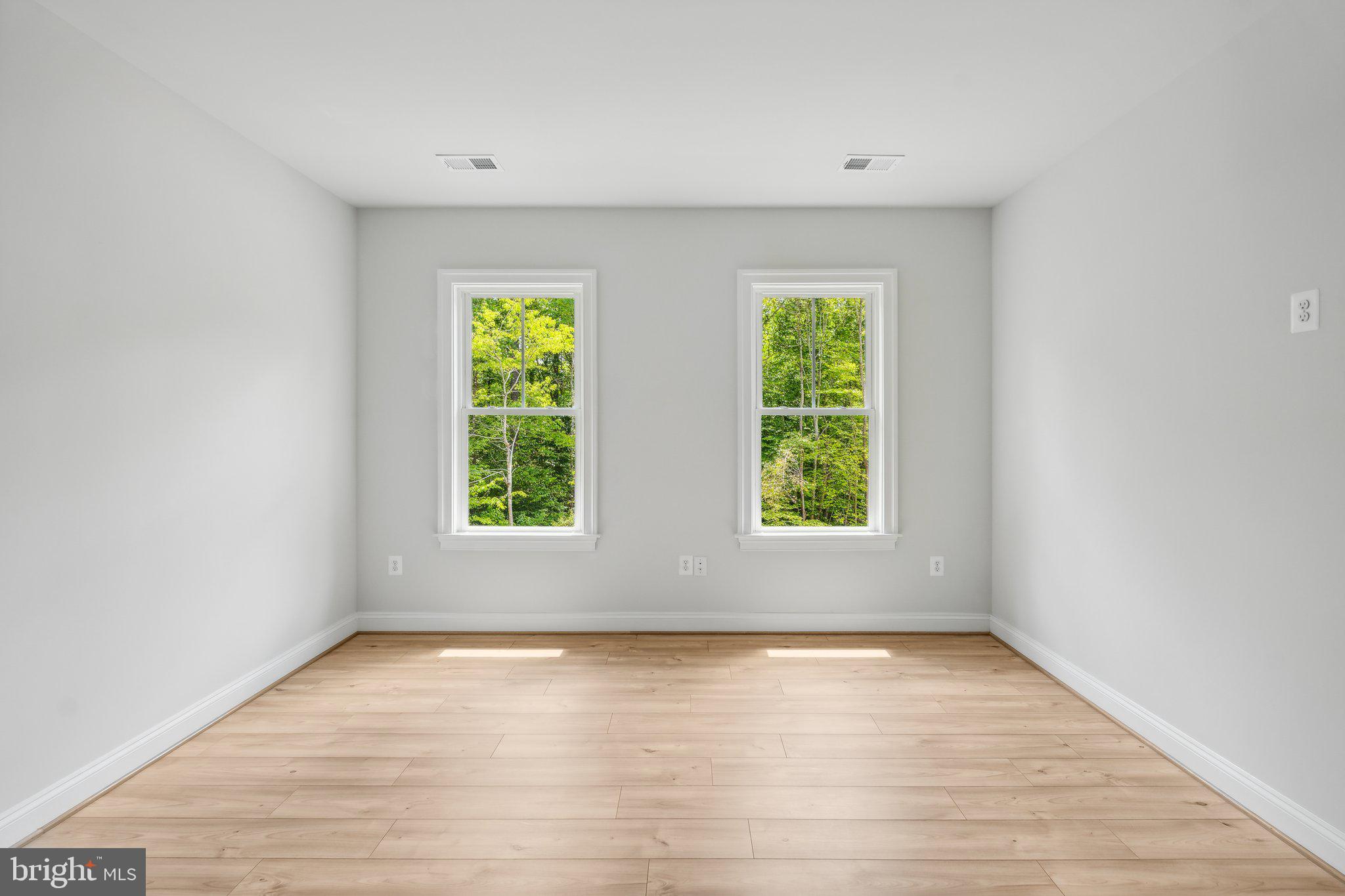 13749 Orlando Road Nokesville, VA 20181 - Photo 7 of 42 an empty room with wooden floor and windows