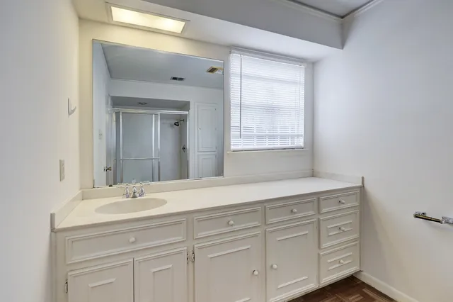 a bathroom with a sink vanity and mirror