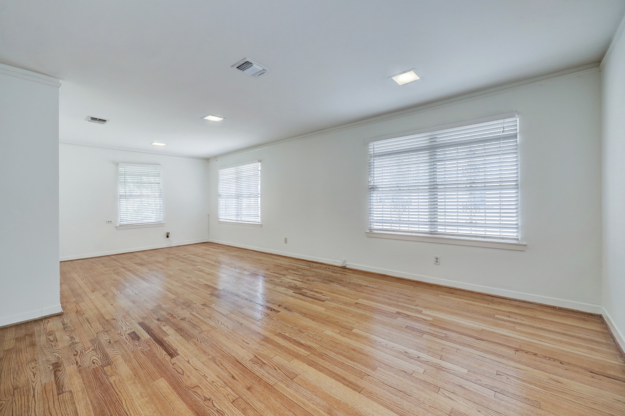4002 Portsmouth Street Houston, TX 77027 - Photo 13 of 15 an empty room with wooden floor and windows