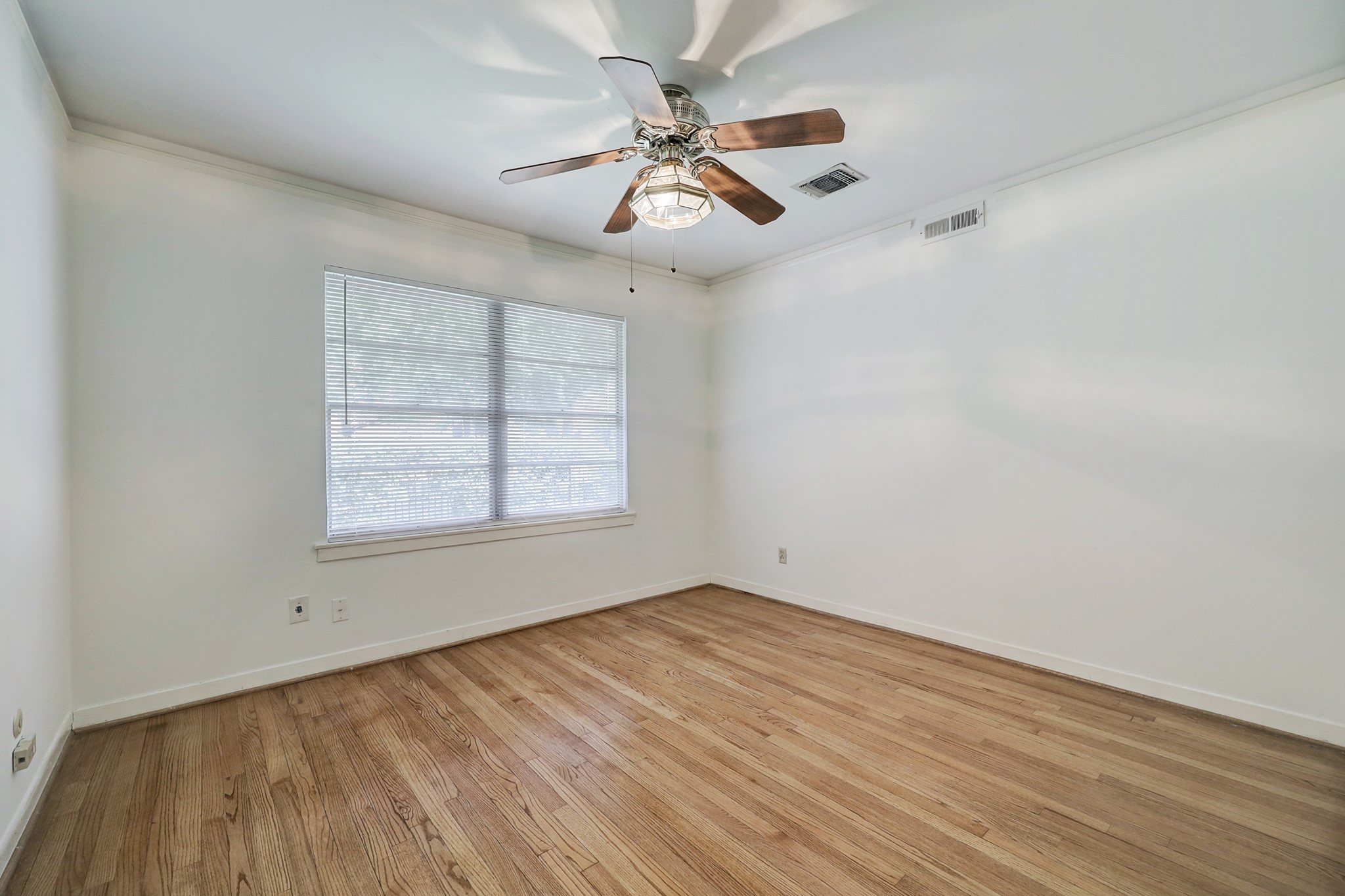 4002 Portsmouth Street Houston, TX 77027 - Photo 14 of 15 wooden floor in an empty room with a window