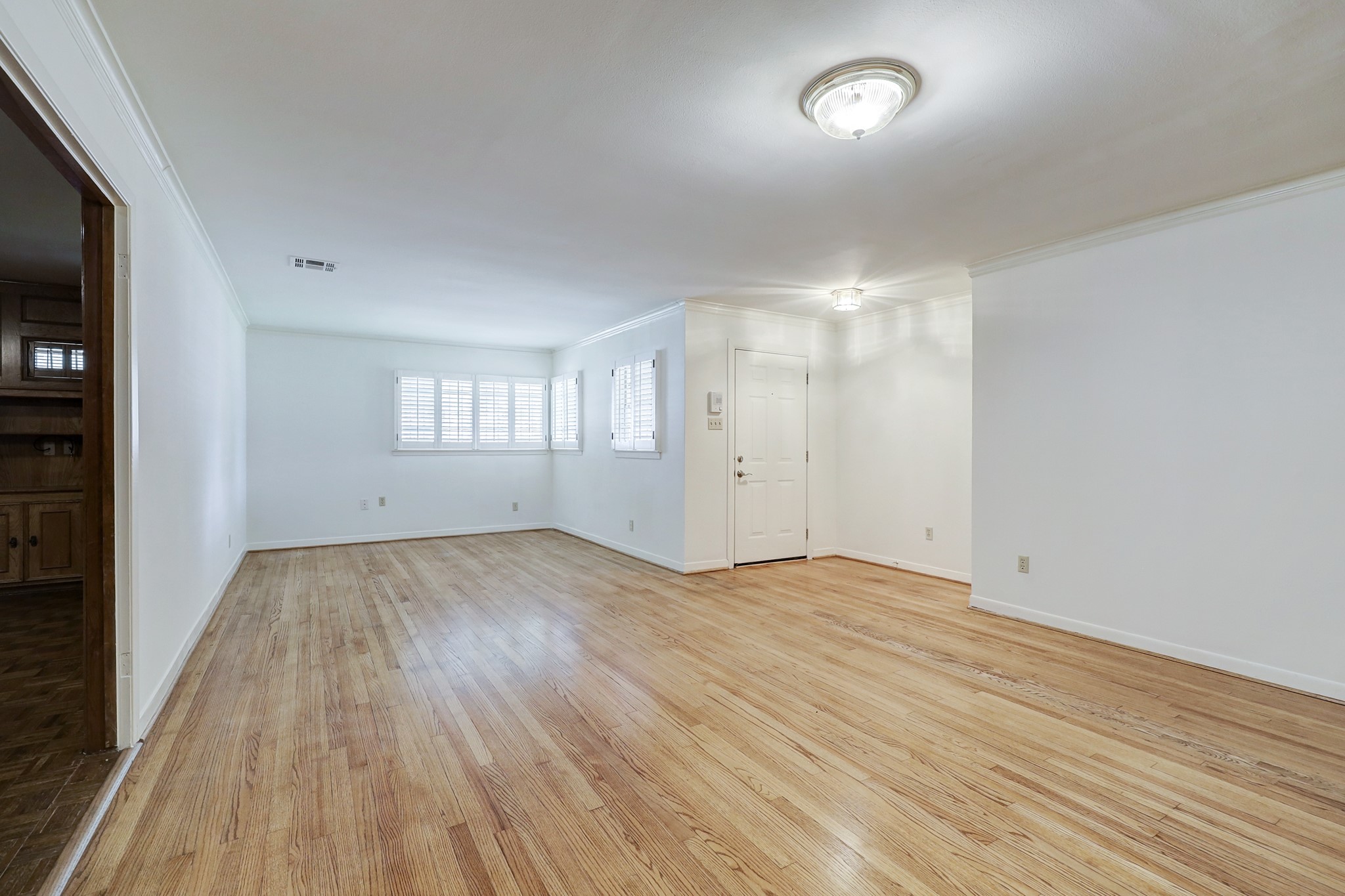 4002 Portsmouth Street Houston, TX 77027 - Photo 3 of 15 an empty room with wooden floor and windows