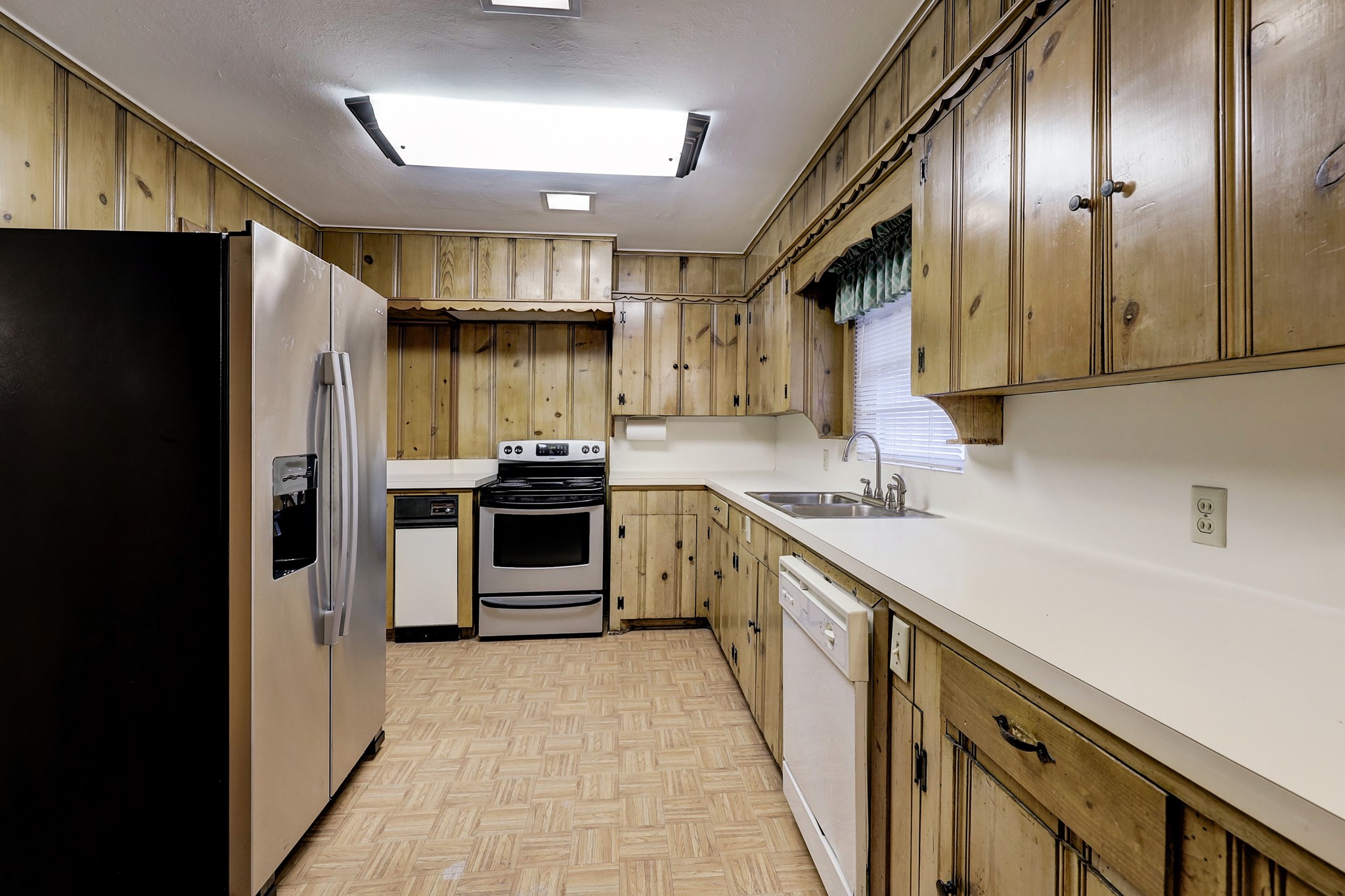 4002 Portsmouth Street Houston, TX 77027 - Photo 7 of 15 a kitchen with stainless steel appliances a refrigerator a sink a stove and cabinets