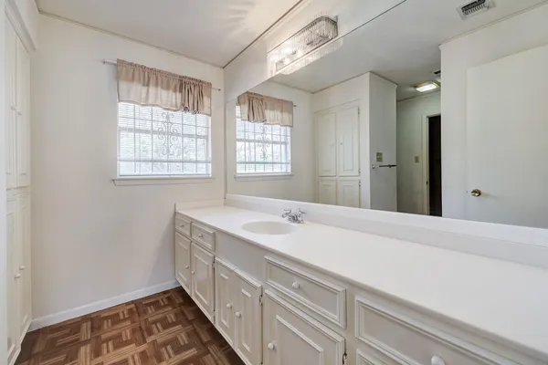 a spacious bathroom with a sink and a window