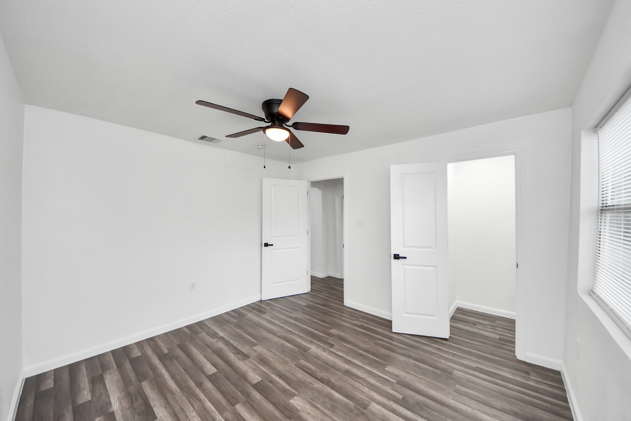 207 East Defee Avenue Baytown, TX 77520 - Photo 30 of 36 a view of empty room with wooden floor and fan