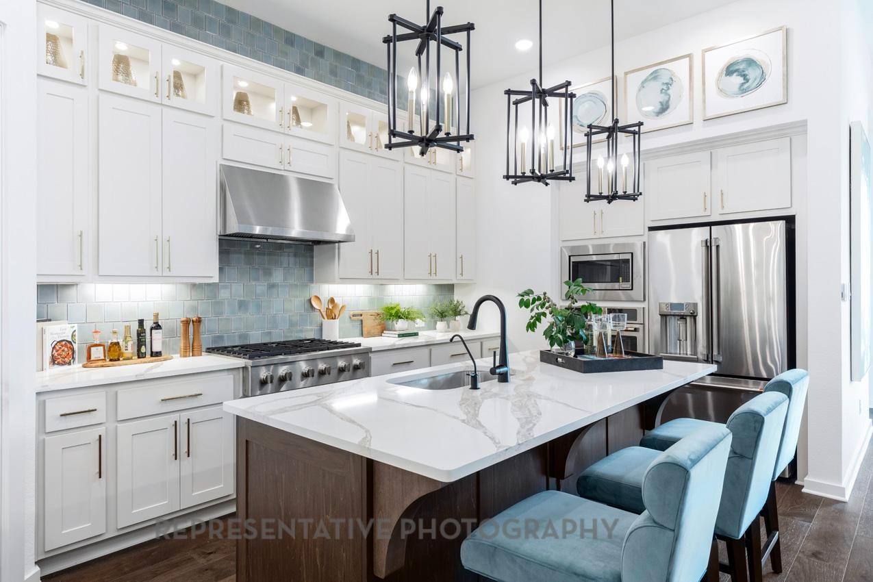 5810 Silver Perch Lane Manvel, TX 77578 - Photo 6 of 18 a kitchen with stainless steel appliances a sink a stove a refrigerator and cabinets
