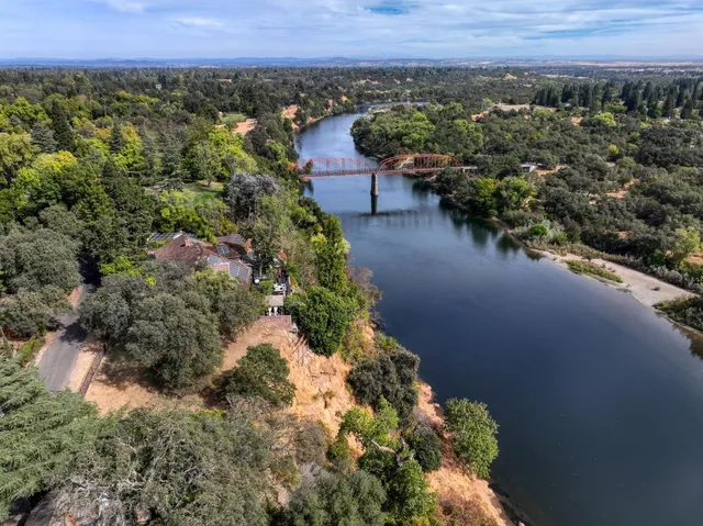 a view of a house with a yard and mountain