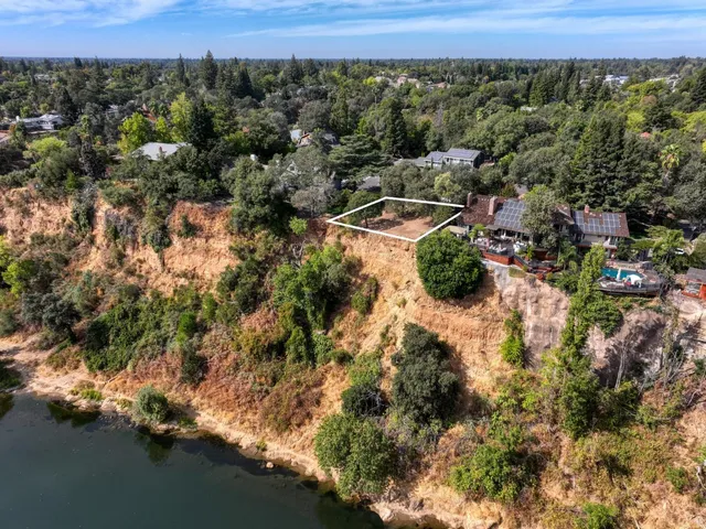 an aerial view of a house with a yard and outdoor seating