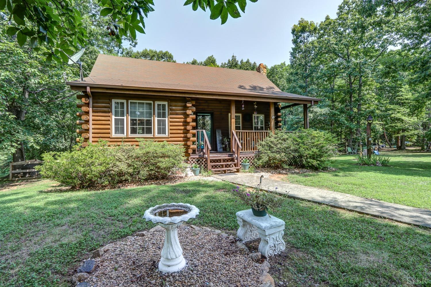 699 Gladys Road Gladys, VA 24554 - Photo 2 of 47 a view of a house with backyard sitting area and garden