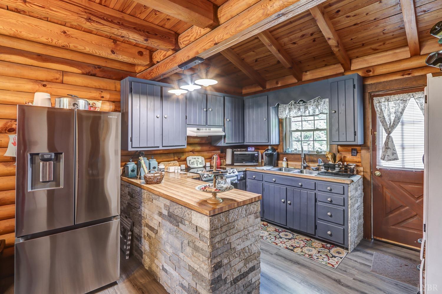 699 Gladys Road Gladys, VA 24554 - Photo 21 of 47 a kitchen with refrigerator and cabinets