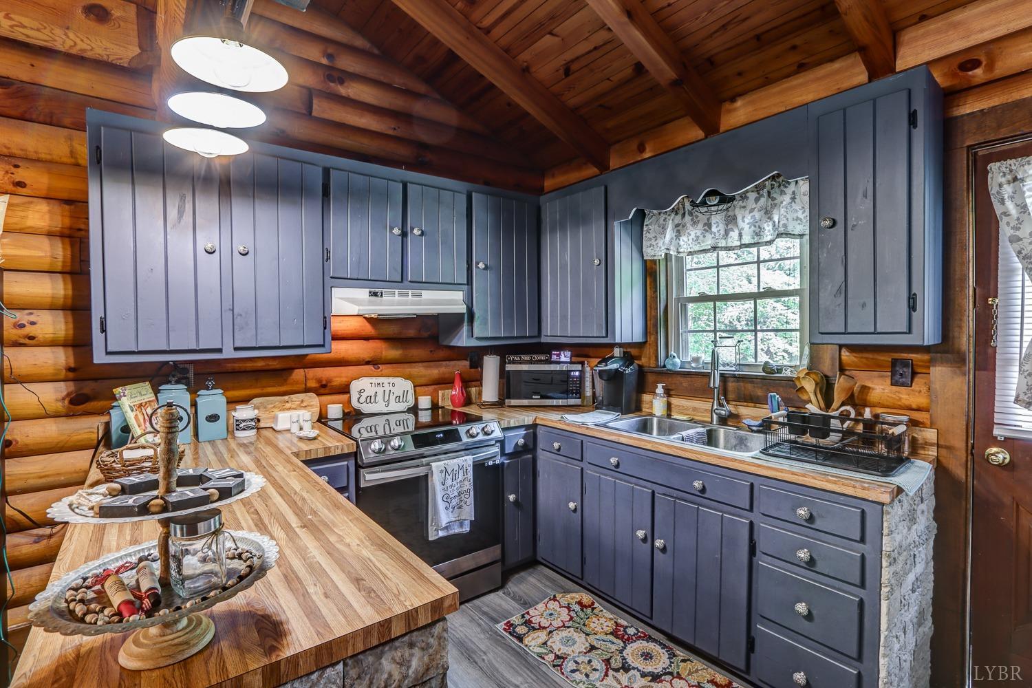 699 Gladys Road Gladys, VA 24554 - Photo 22 of 47 a kitchen with stainless steel appliances wooden cabinets and a stove top oven