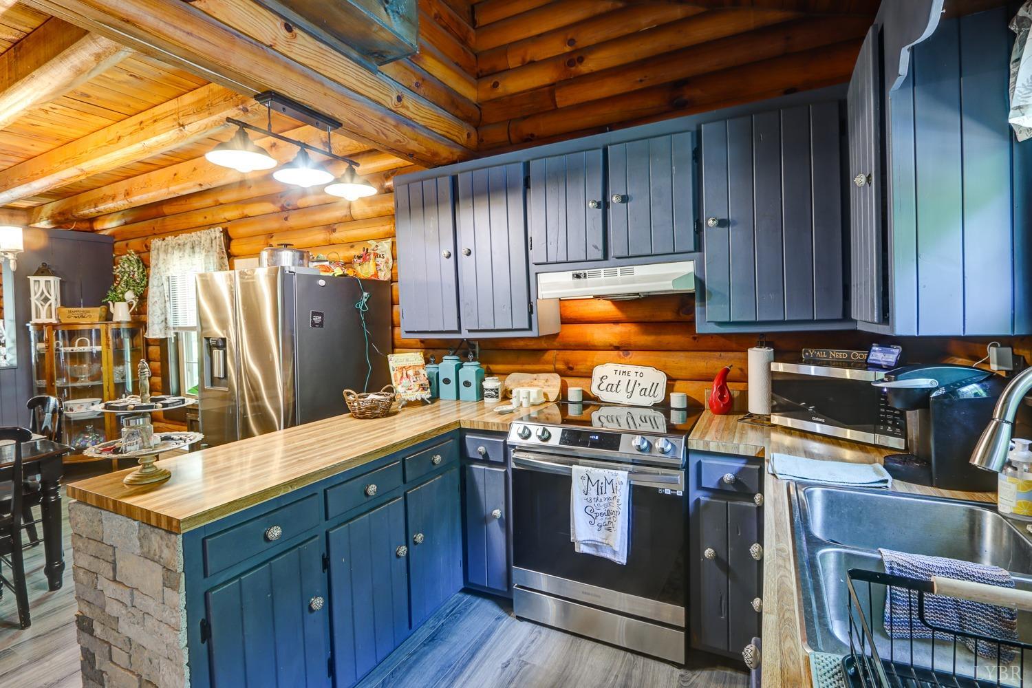 699 Gladys Road Gladys, VA 24554 - Photo 23 of 47 a kitchen with stainless steel appliances granite countertop a stove a sink dishwasher and cabinets