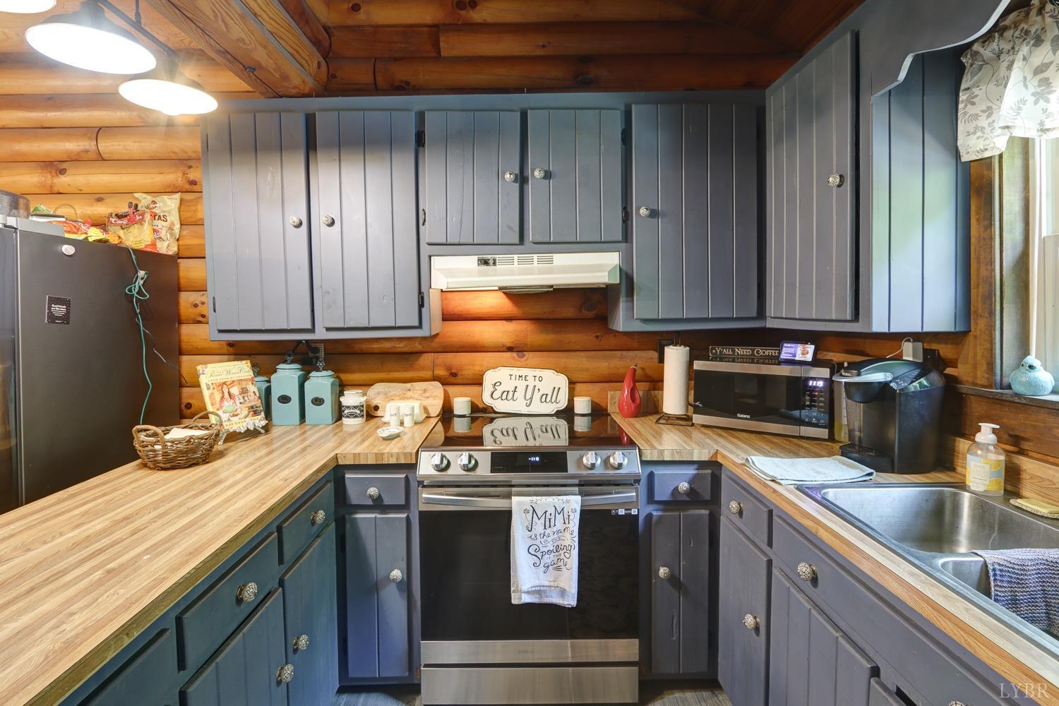 699 Gladys Road Gladys, VA 24554 - Photo 24 of 47 a kitchen with granite countertop a sink a stove and cabinets