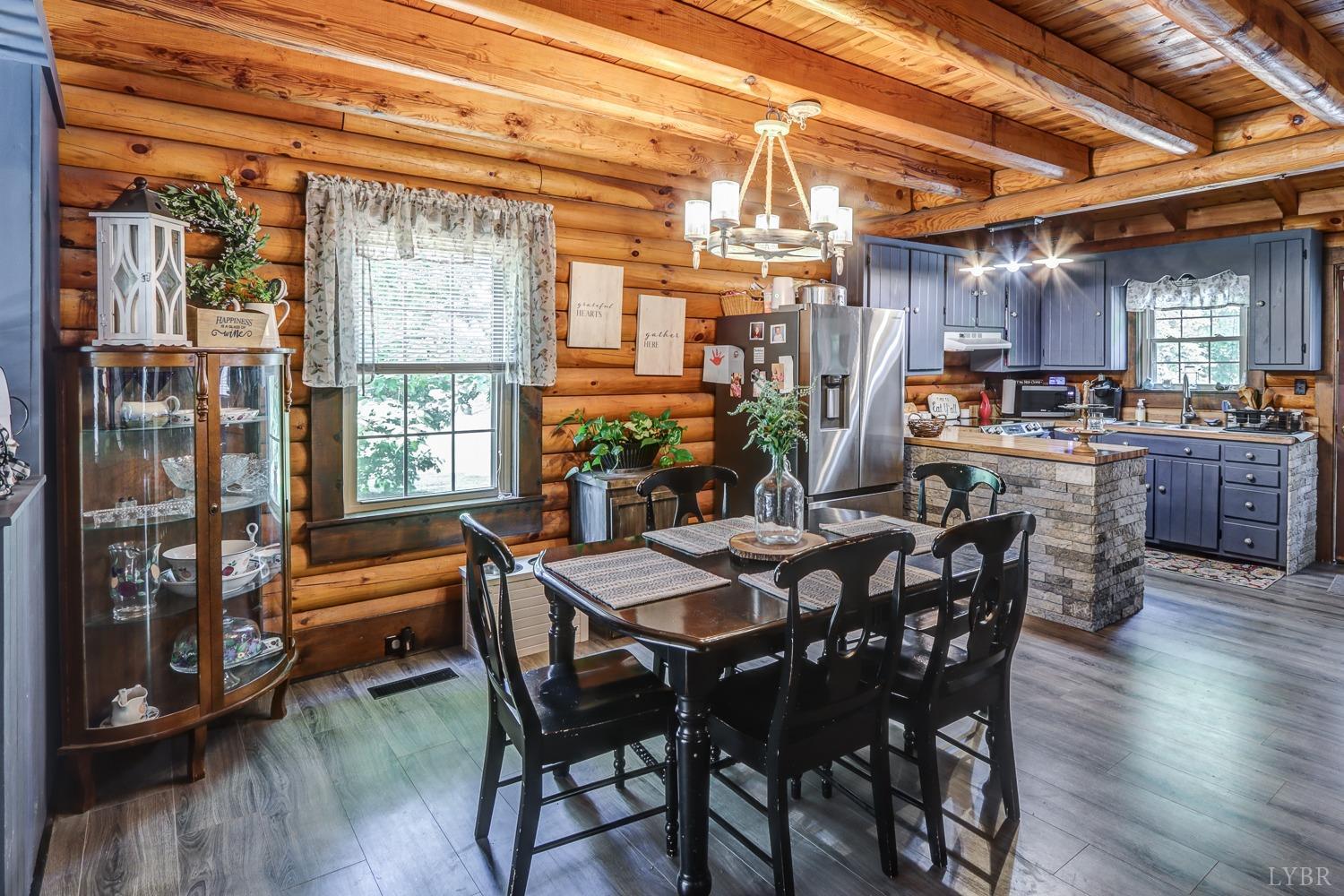 699 Gladys Road Gladys, VA 24554 - Photo 31 of 47 a view of a dining room with furniture window and wooden floor