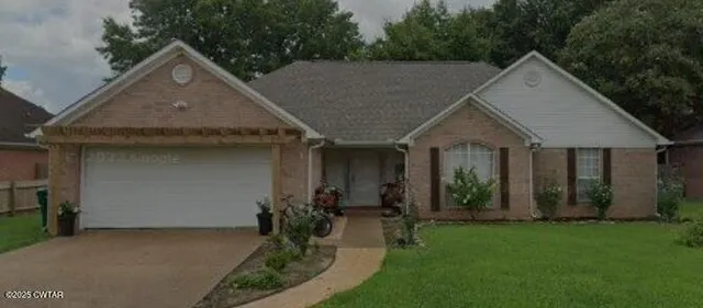 a front view of house with green space