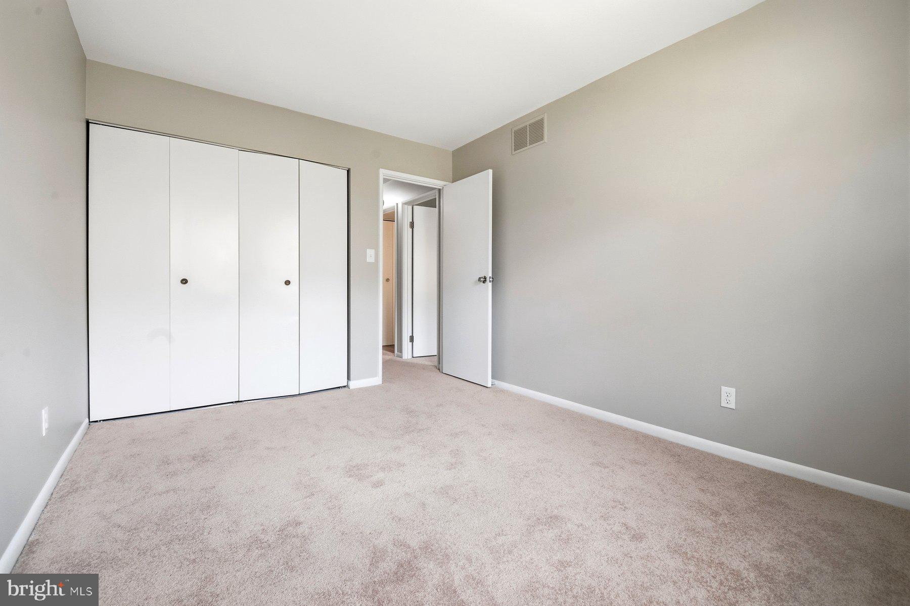 9080 Moonshine Hollow, Unit F Laurel, MD 20723 - Photo 19 of 24 Spacious room with neutral tones.