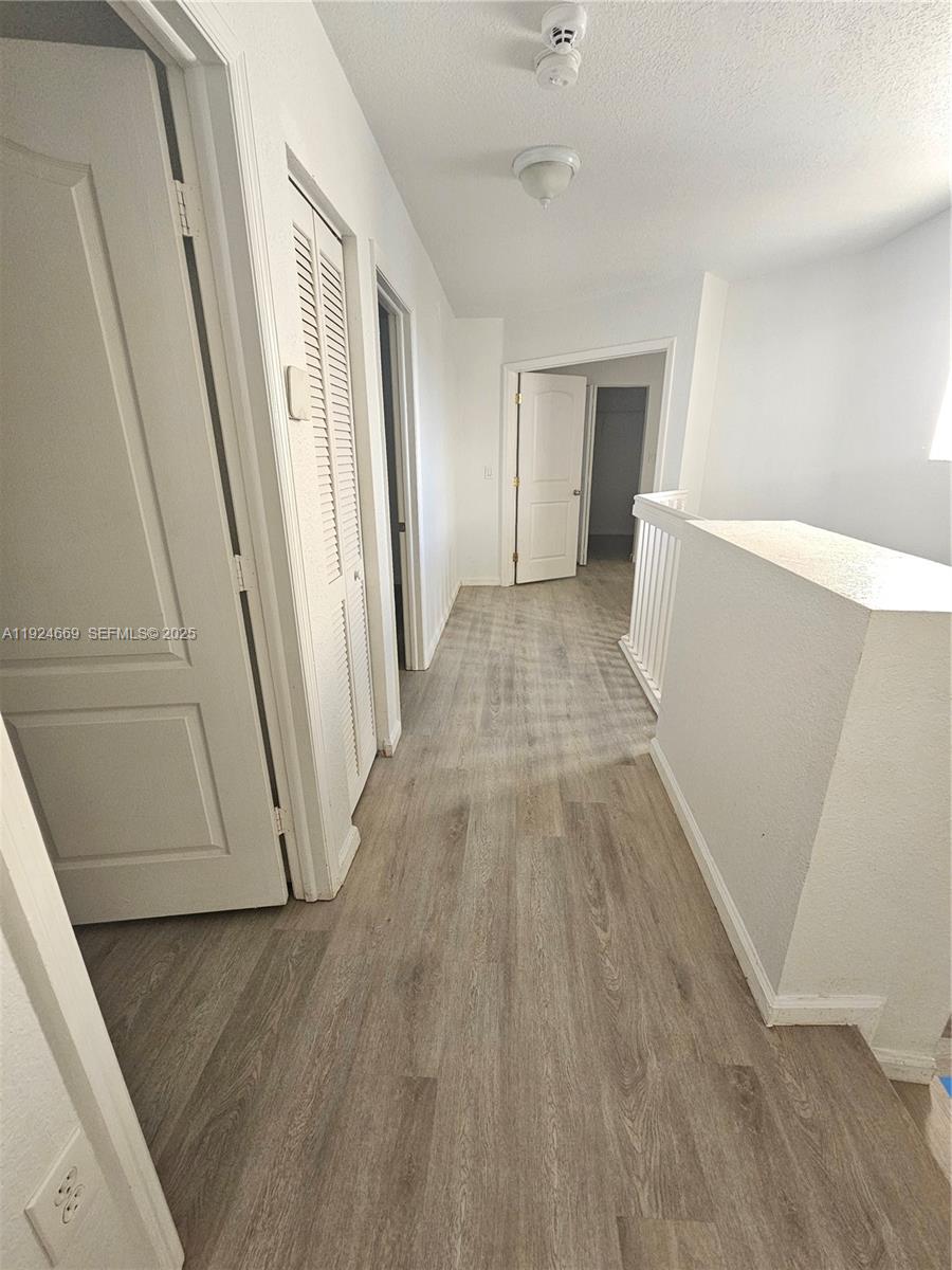 15447 Southwest 151st Street Miami, FL 33196 - Photo 15 of 25 a view of a room with wooden floor and staircase